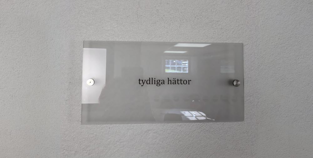 Etsning av text på glas med texten "tydliga hättor".